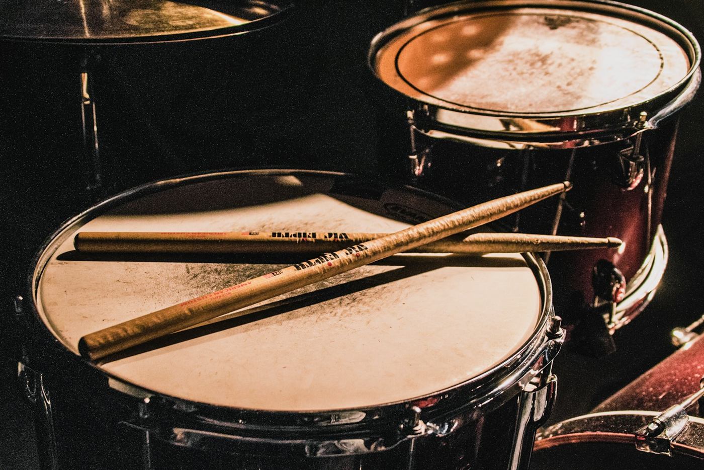Drummer performing behind a drum kit